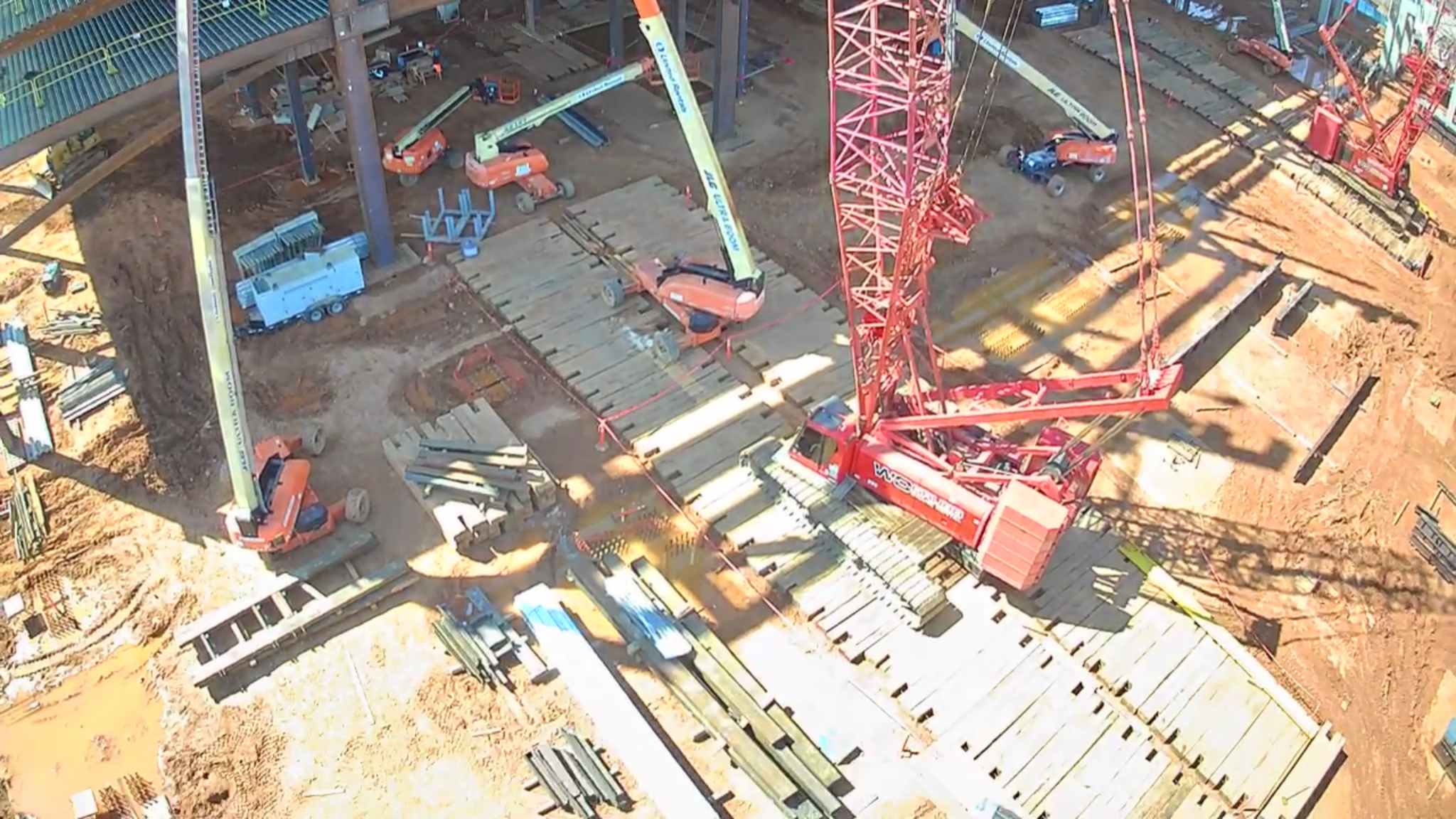 Ironworkers positioning structural steel on building frame